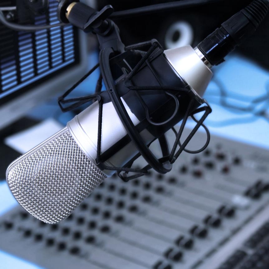 4958642-A-mic-in-front-of-the-control-panel-in-broadcasting-studio-Stock-Photo